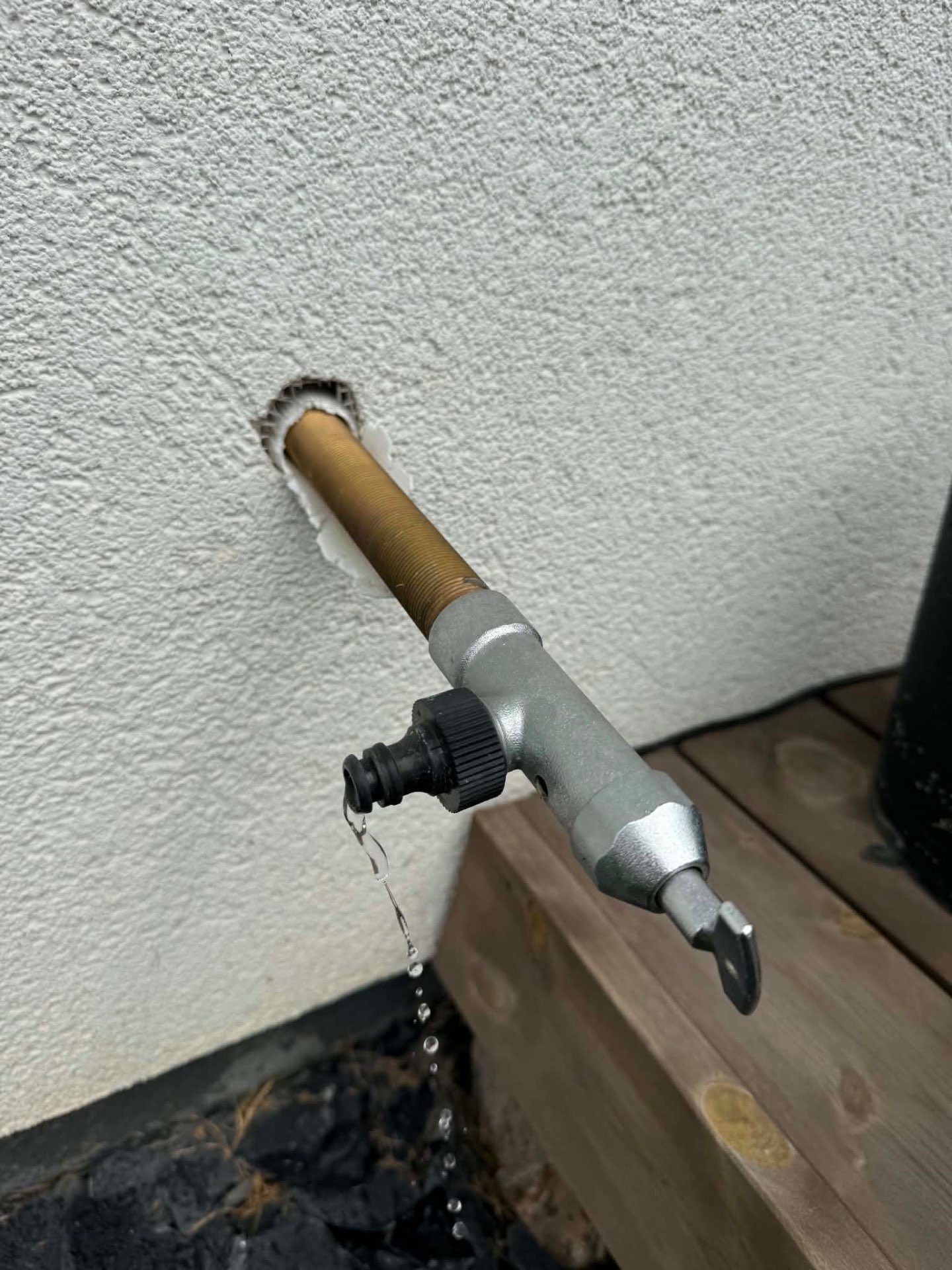 Outdoor garden tap — before (leaking, too long)