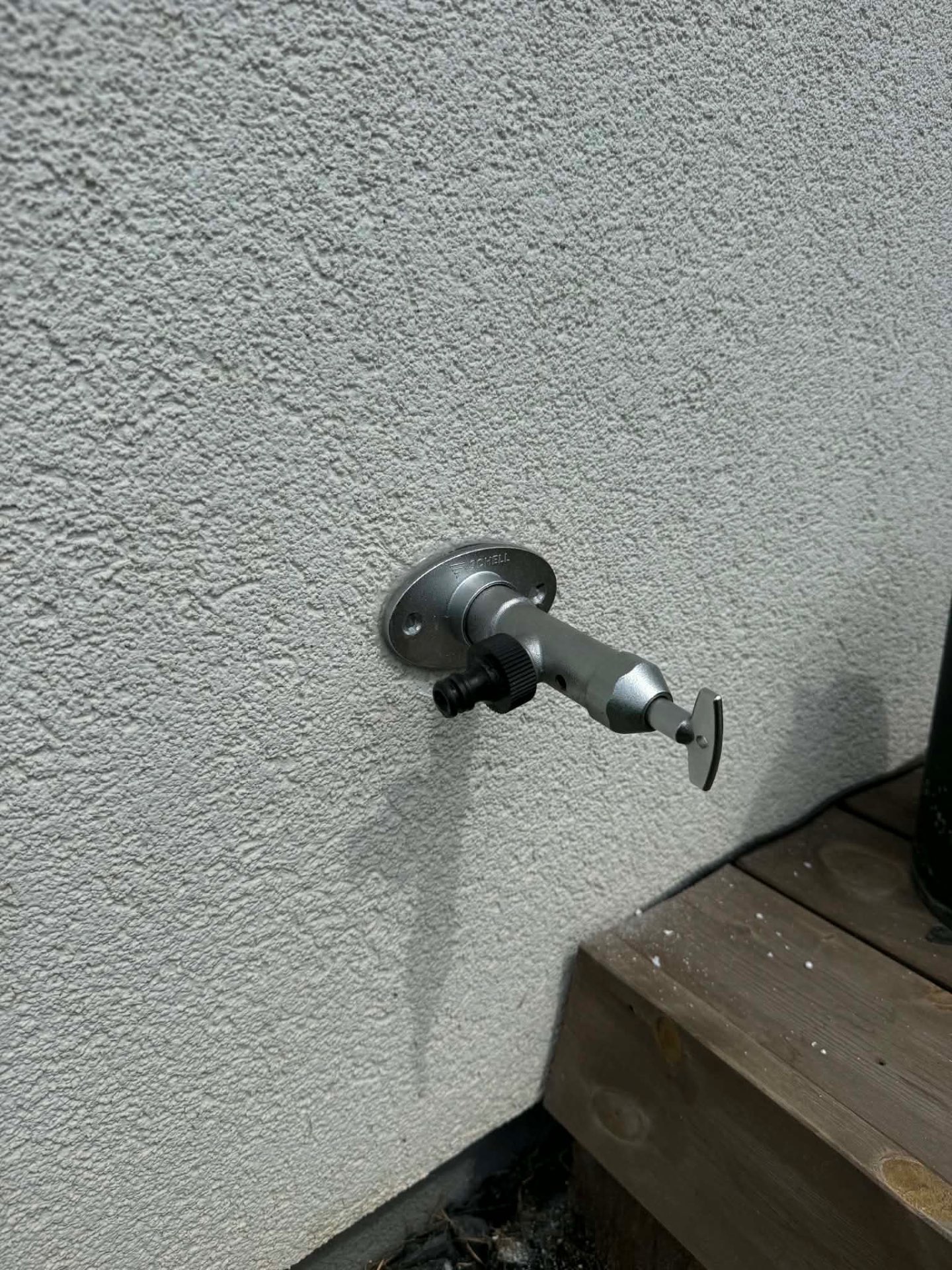 Outdoor garden tap shortened and secured — after